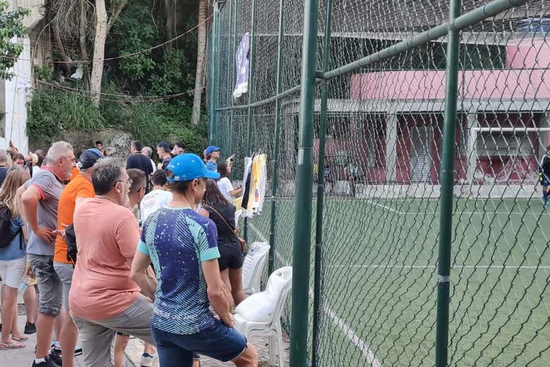 Público vendo a partida de futebol na favela Santa Marta