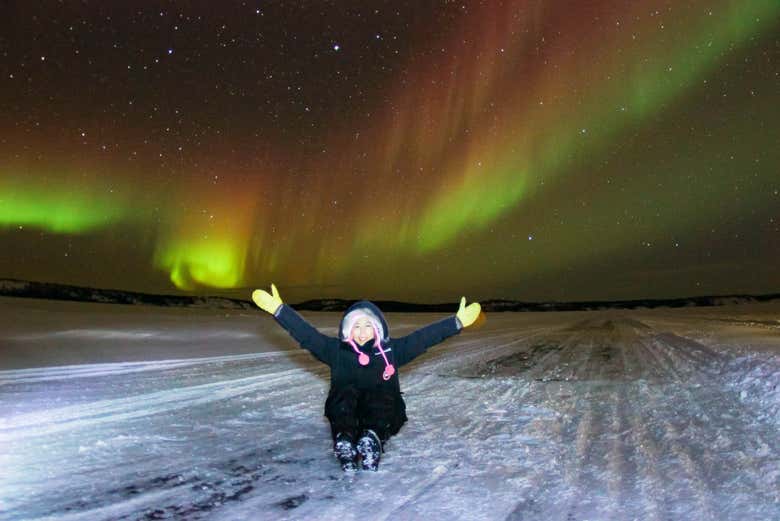 Chasse aux aurores boréales en hiver sur une route de glace