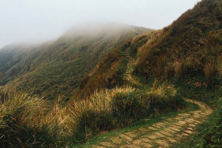 Hike on a trail surrounded by mountains