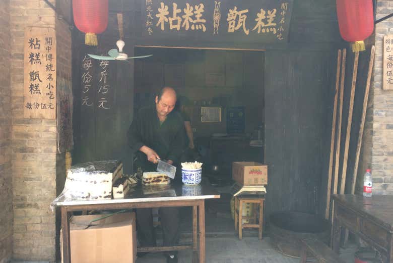 A man working in a shop in Yuanjiacun Village