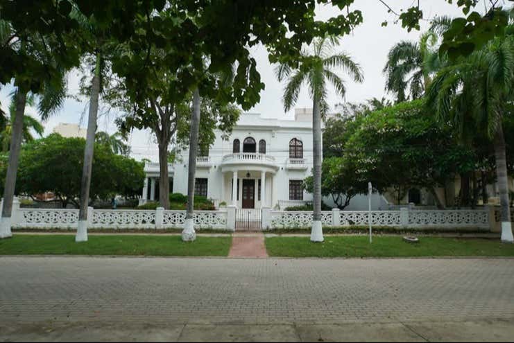 Pass by El Prado's tree-lined avenues
