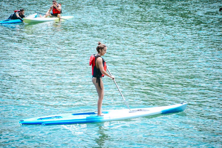 Paddle surf on the Arenal Lake waters