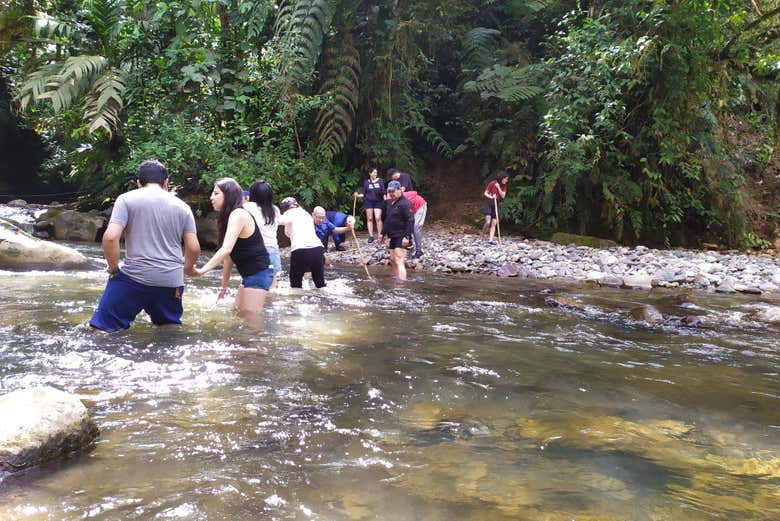 Crossing a river in Cayambe Coca National Park
