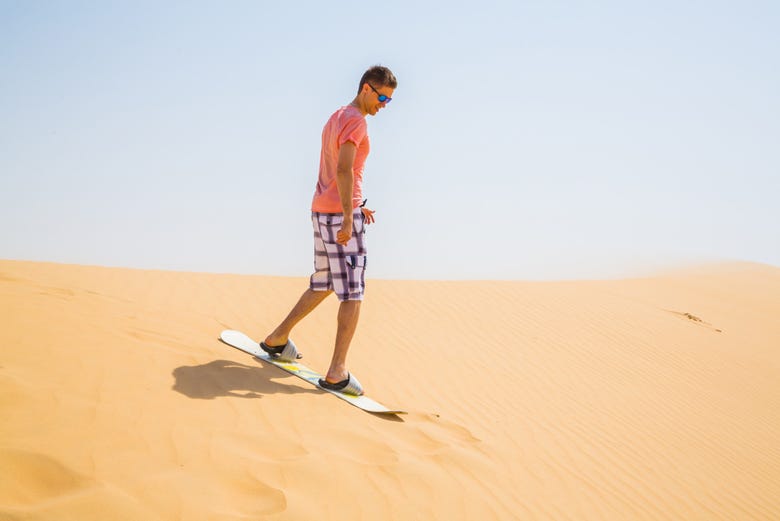 Enjoying sandboarding in the Dubai desert