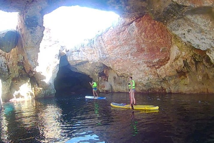 Paddling through a cave in Cales Coves