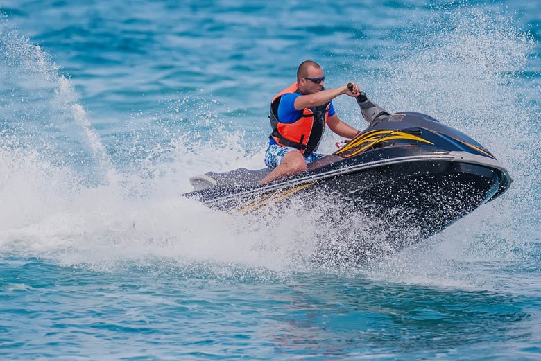 Riding a jet ski in Fornells