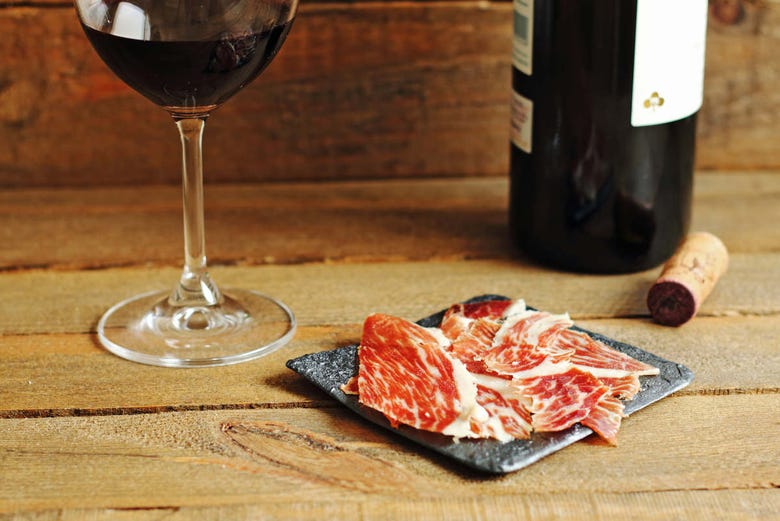 Sample a glass of wine and Spanish ham