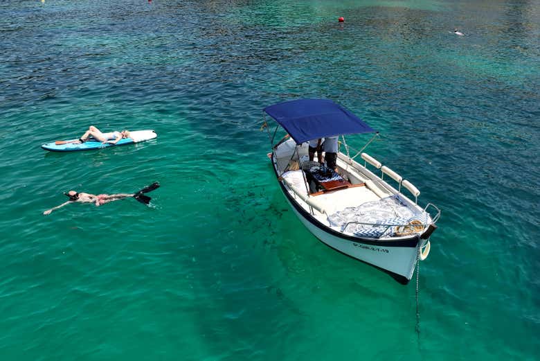 Practicando snorkel y paddle surf junto al llaüt