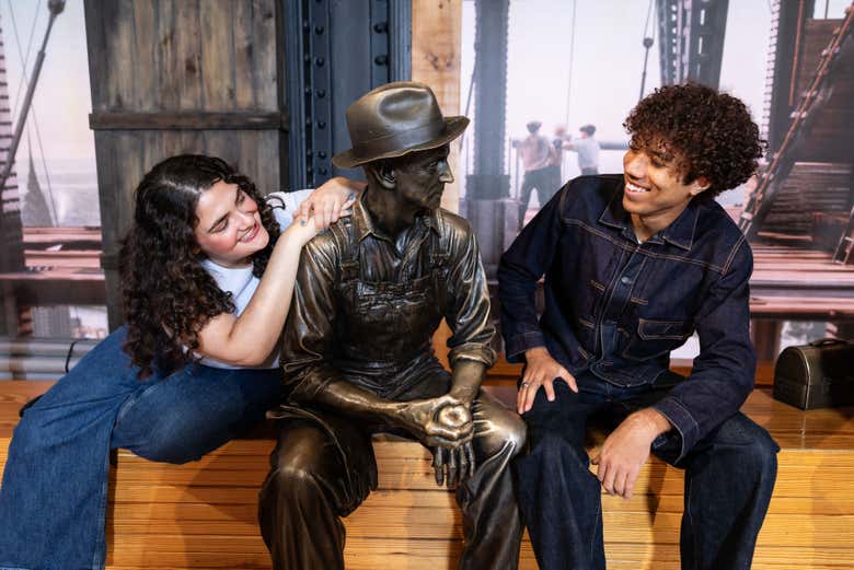 Pose with a statue from the exhibition in the Empire State