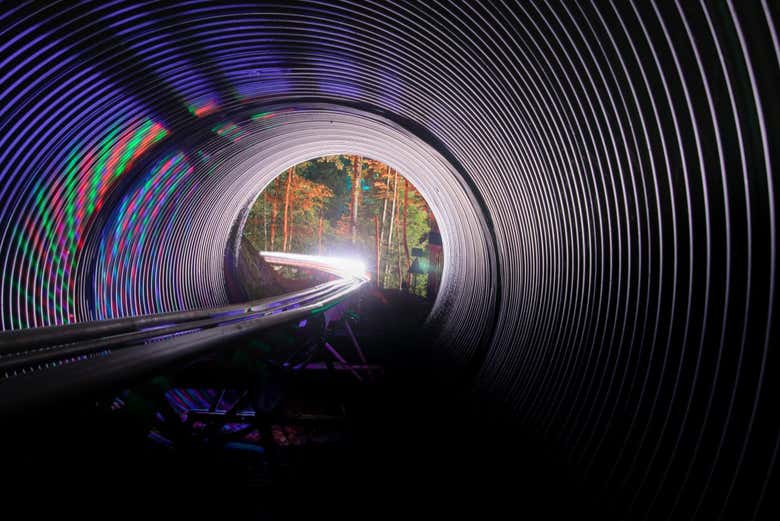 Glide through the tunnels lit up at night