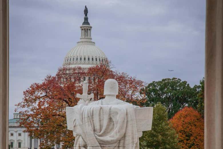 A statue in front of the Capitol