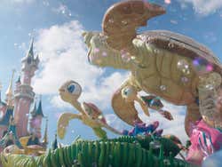 A float of turtles passing the pink castle
