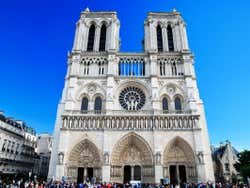 Facade of Notre Dame under a deep blue sky