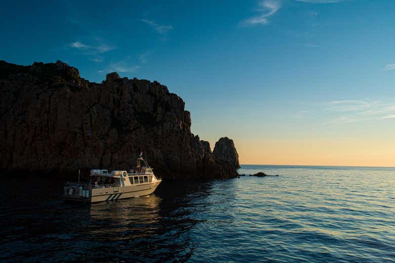 Sailing at sunset in the coves of Piana