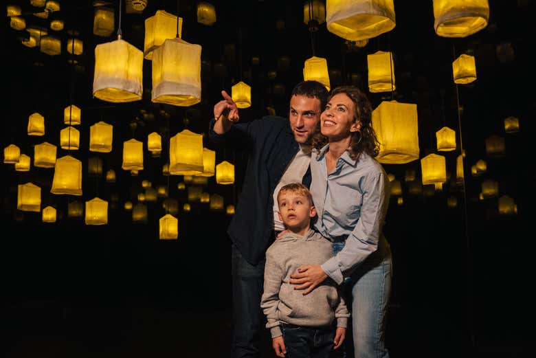A family having fun at IKONO surrounded by lanterns