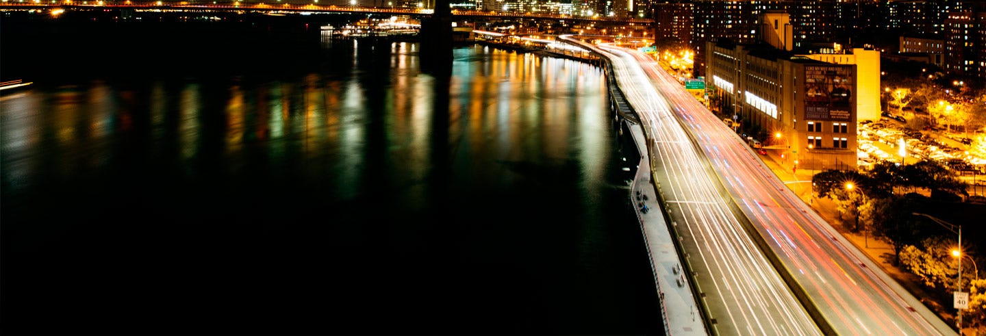 Traffic light trails on a Milan road at night