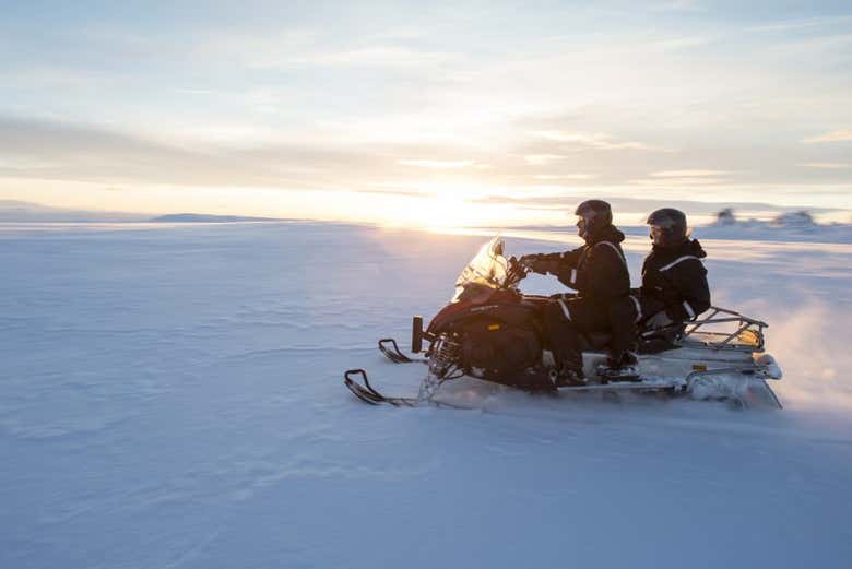 Driving a snowmobile over a glacier in Iceland