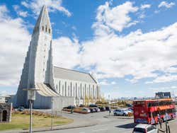 Reykjavik sightseeing bus next to the iconic Hallgrimskirkja