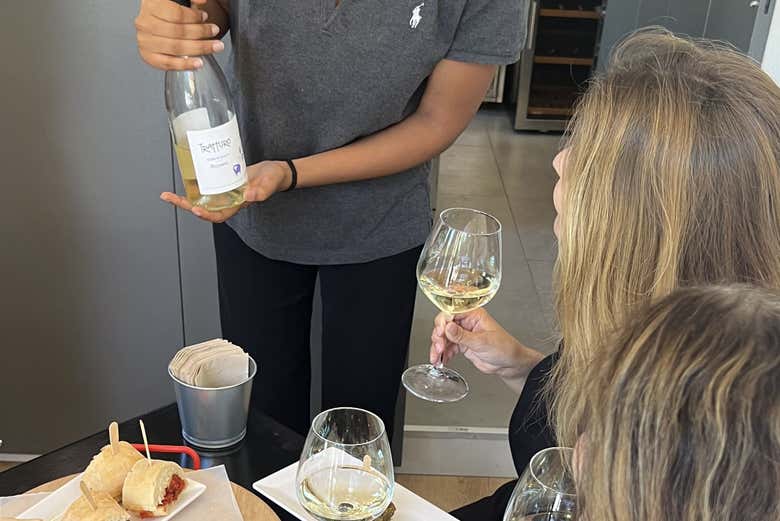 Camarera presentando la botella de vino