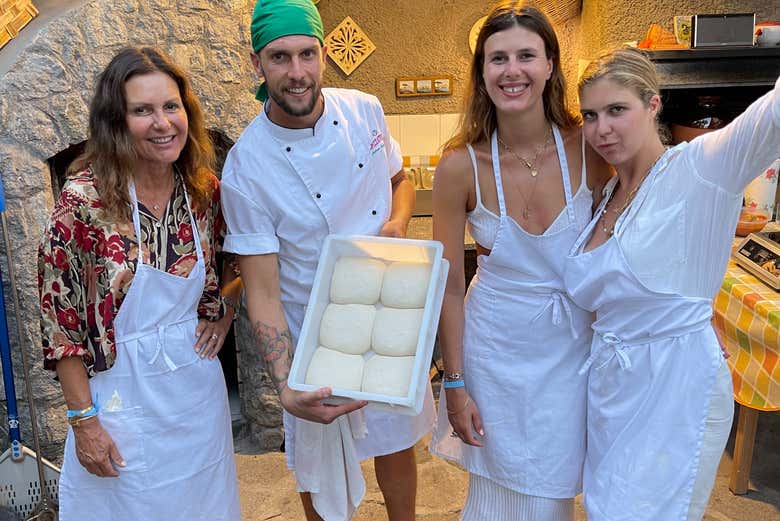 A group showcasing the pizza dough they made