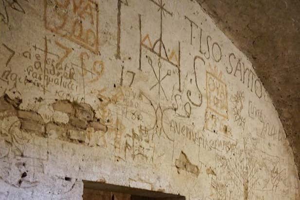 Examine the inscriptions on the walls below ground