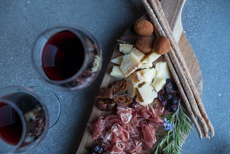 A wine tasting, accompanied by a cheese and meat board