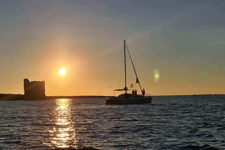 A boat sailing at sunset in the Gulf of Asinara