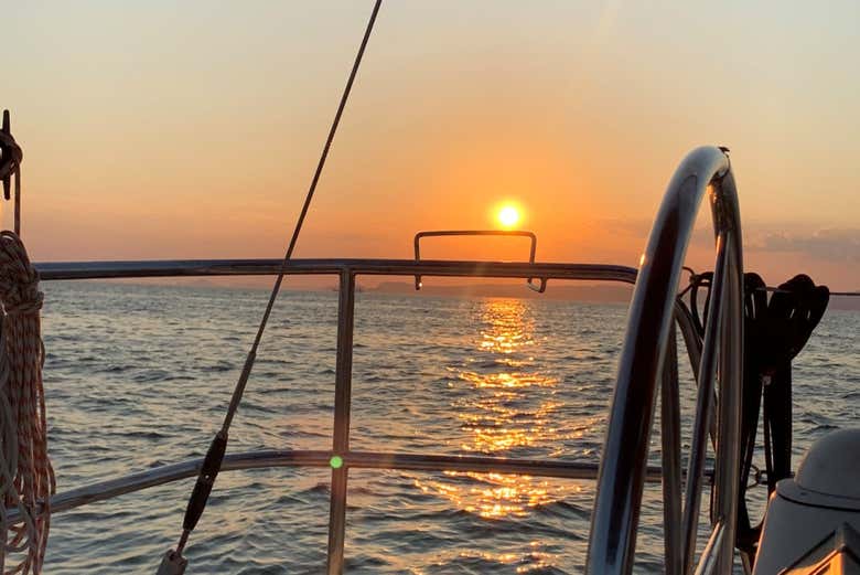 Feel the magic of sailing while the sky turns gold
