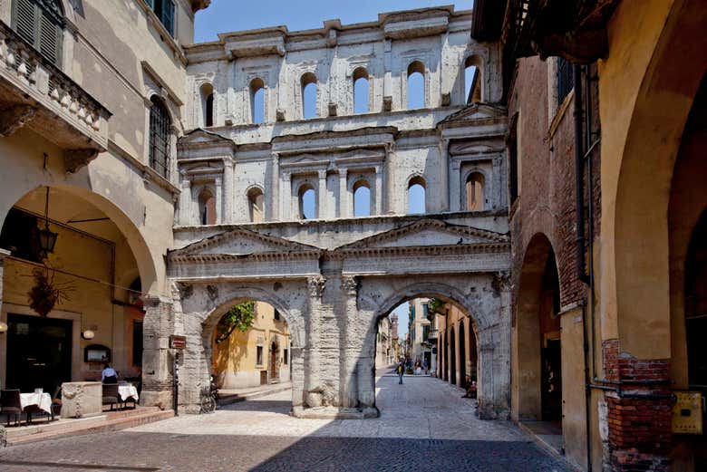 Wander through the arches of Porta Borsari