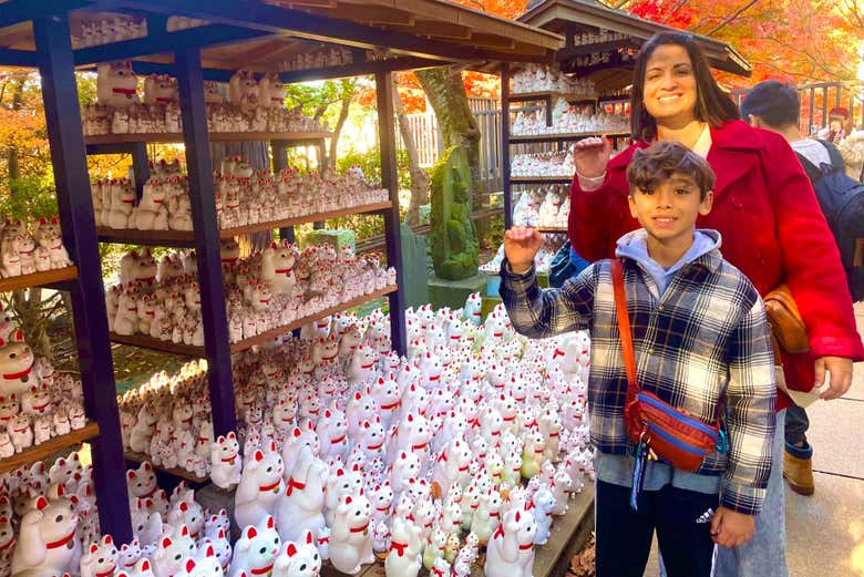 Pose with the lucky maneki neko figures