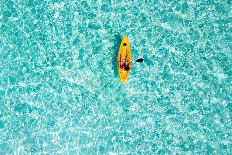 Paddling in the crystal clear waters of Maafushi