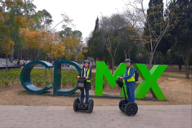 Passando de segway ao lado do letreiro da CDMX