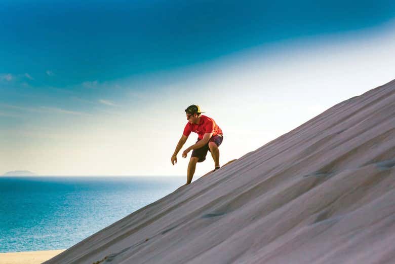 Go sand boarding in the desert
