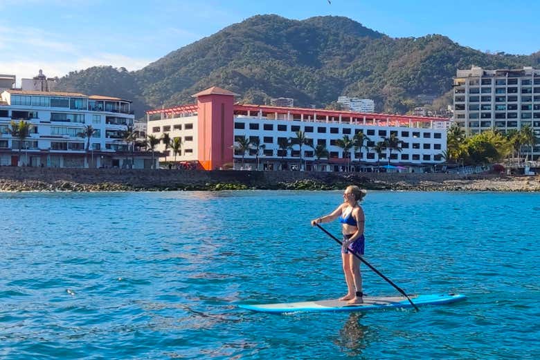 A woman enjoying paddle boarding