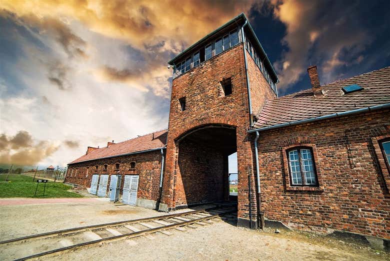 Walk through the main entrance to Auschwitz-Birkenau