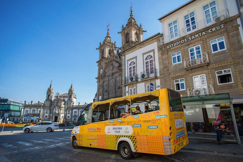 The sightseeing bus in front of some historic churches