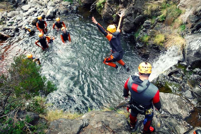 Jumping off the rocks into natural pools 