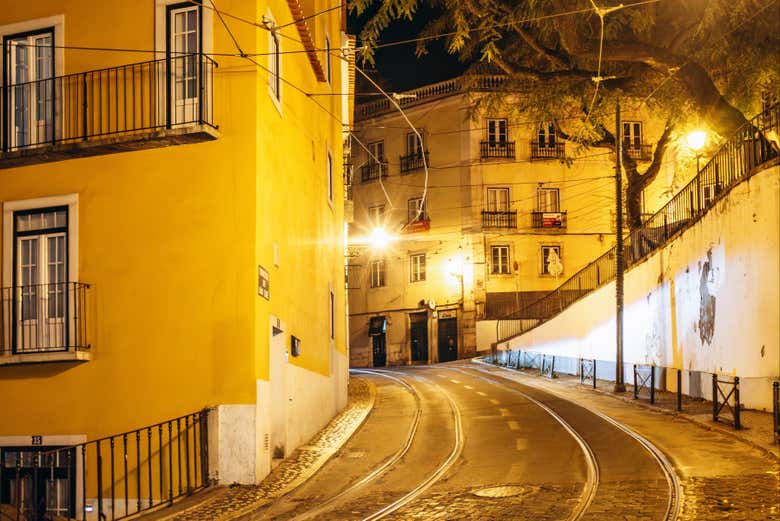 Wander through the golden-lit streets of Alfama after dark