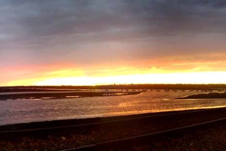 The sun setting and tinging the skies orange