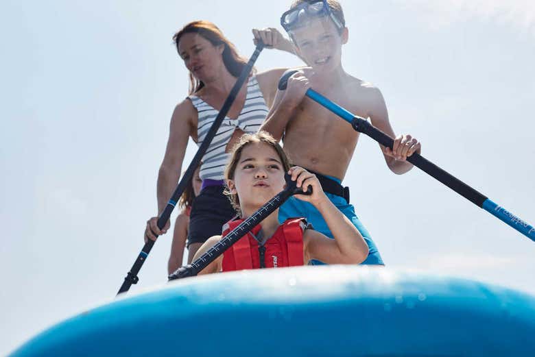 Family enjoying the paddleboarding activity