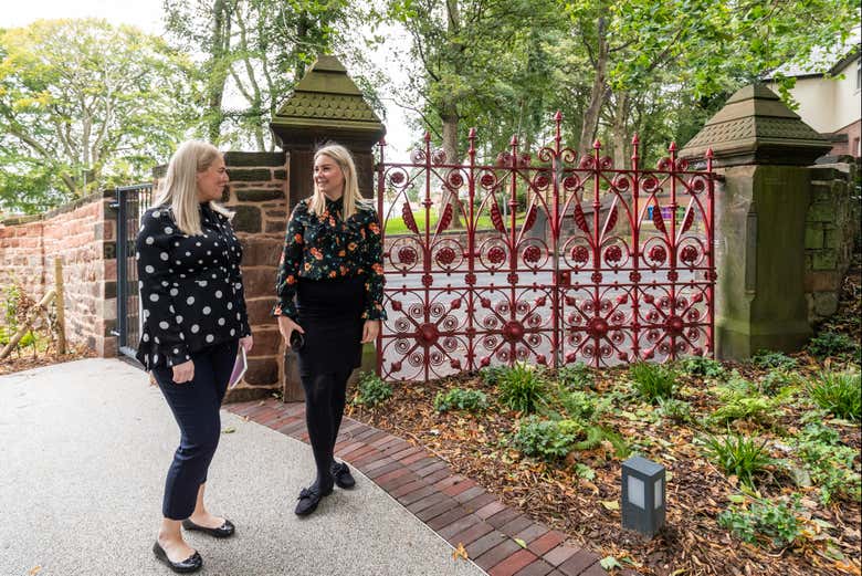 Visitors stepping beyond the red gates