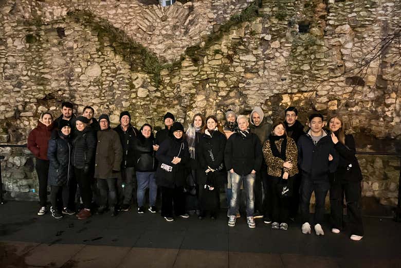 Gather beside a surviving stretch of the Roman wall