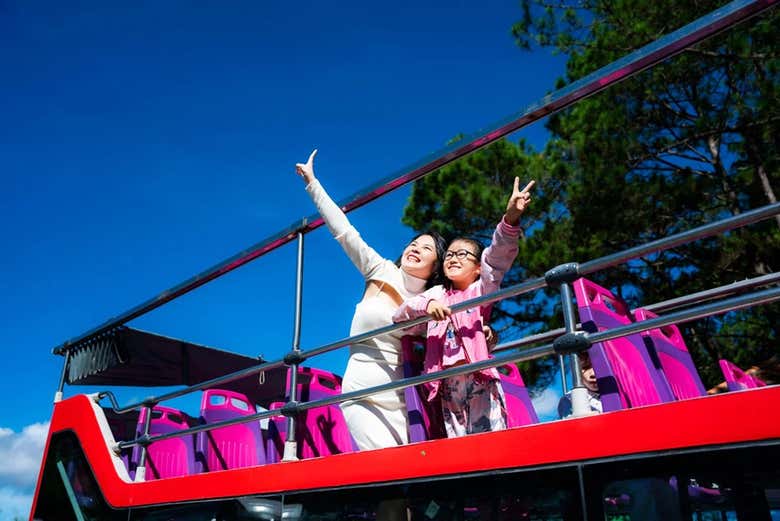 Deux personnes sur le toit du bus touristique